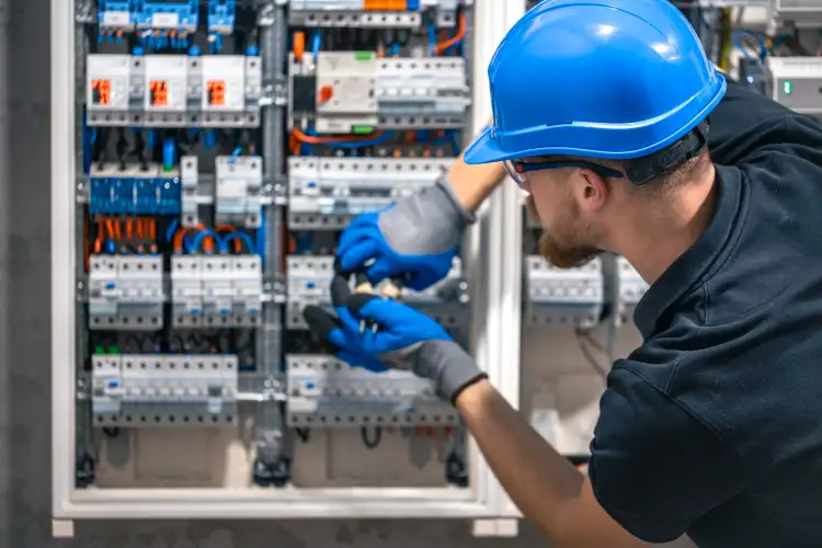 Electrician working on a building services panel