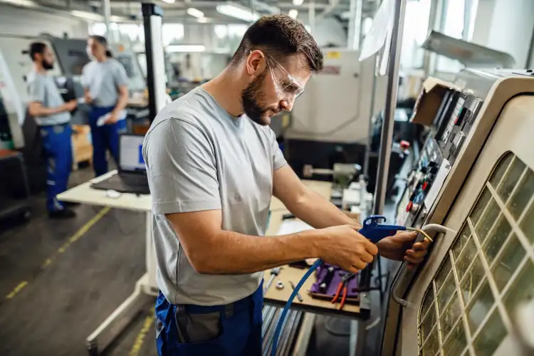 Industrial maintenance technician servicing production equipment